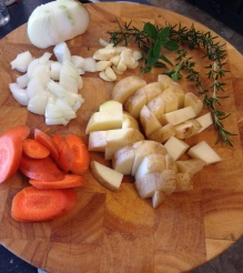 Chopped up carrots, potatoes, onion. garlic, and herbs